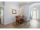 Charming dining room with a glass table, wood chairs, and soft blue walls and decor at 10105 Holly Berry Dr, Weeki Wachee, FL 34613