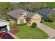 Aerial view of a well-maintained home featuring a manicured lawn and a driveway at 10105 Holly Berry Dr, Weeki Wachee, FL 34613