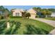Well-maintained home featuring a neatly manicured lawn, front shrubs, and a driveway at 10105 Holly Berry Dr, Weeki Wachee, FL 34613