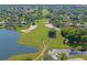 Aerial view of a lush golf course with sand traps and water hazards in a residential community at 10105 Holly Berry Dr, Weeki Wachee, FL 34613