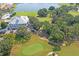 Aerial view of a golf course with lush fairways and picturesque landscaping, perfect for recreation at 10105 Holly Berry Dr, Weeki Wachee, FL 34613