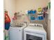 This laundry room features a full-size washer and dryer, with plenty of shelf space for storage and supplies at 10105 Holly Berry Dr, Weeki Wachee, FL 34613