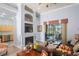Cozy living room featuring a fireplace, built-in shelving, and access to a screened lanai at 10105 Holly Berry Dr, Weeki Wachee, FL 34613