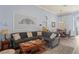Comfortable living room features a sectional sofa, decorative rug, and adjacent dining area at 10105 Holly Berry Dr, Weeki Wachee, FL 34613
