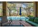 Screened lanai includes cozy outdoor seating surrounding the pool, perfect for gatherings and enjoying the view at 10105 Holly Berry Dr, Weeki Wachee, FL 34613