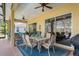 This covered and screened patio features ample seating and dining options, ideal for entertaining or relaxing by the pool at 10105 Holly Berry Dr, Weeki Wachee, FL 34613