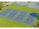 Aerial view of community pickleball courts, a fun recreational amenity for active residents at 10105 Holly Berry Dr, Weeki Wachee, FL 34613