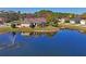 Scenic view of home by the pond, with well-maintained lawn and landscaping, enhancing its curb appeal at 10105 Holly Berry Dr, Weeki Wachee, FL 34613