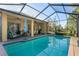 Enjoy the pool views from the screened lanai with ample space for lounge chairs and outdoor dining at 10105 Holly Berry Dr, Weeki Wachee, FL 34613