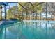 This screened pool is surrounded by mature trees, and landscaping providing a private oasis for relaxation and recreation at 10105 Holly Berry Dr, Weeki Wachee, FL 34613
