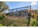 Enjoy outdoor living with this home's spacious screened-in patio and well-kept yard at 10105 Holly Berry Dr, Weeki Wachee, FL 34613