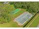 Aerial view of community shuffleboard courts surrounded by lush landscaping and greenery at 10105 Holly Berry Dr, Weeki Wachee, FL 34613