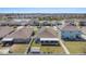 Aerial view of home with solar panels on roof, screened in lanai, and large backyard at 1014 Coastal Hammock Ave, Ruskin, FL 33570