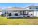 A well-manicured lawn leads to a screened in lanai with grilling area at 1014 Coastal Hammock Ave, Ruskin, FL 33570