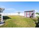 Lush backyard with a storage shed, bird bath, and a privacy fence at 1014 Coastal Hammock Ave, Ruskin, FL 33570