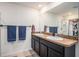 Modern bathroom featuring double sinks, granite countertops, and a shower at 1014 Coastal Hammock Ave, Ruskin, FL 33570