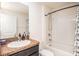 Well-lit bathroom featuring granite countertops, a bathtub, and a shower, offering a refreshing and functional space at 1014 Coastal Hammock Ave, Ruskin, FL 33570