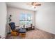 Cozy room with a rocking chair and ottoman set next to the window, carpet floors, and a ceiling fan at 1014 Coastal Hammock Ave, Ruskin, FL 33570