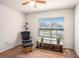 Cozy room with a rocking chair and ottoman set next to the window, carpet floors, and a ceiling fan at 1014 Coastal Hammock Ave, Ruskin, FL 33570
