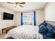 Bedroom with a ceiling fan, a bed, and natural light from the window at 1014 Coastal Hammock Ave, Ruskin, FL 33570