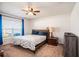 Cozy bedroom with a ceiling fan, window, and comfortable bedding at 1014 Coastal Hammock Ave, Ruskin, FL 33570