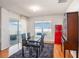 Bright dining area featuring hardwood floors, retro refrigerator, and sliding glass doors to outdoor patio at 1014 Coastal Hammock Ave, Ruskin, FL 33570