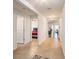 Inviting hallway leading to bedrooms and living areas, featuring neutral tile flooring and ample natural light at 1014 Coastal Hammock Ave, Ruskin, FL 33570