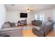 Comfortable living room with hardwood floors, a ceiling fan, and plenty of seating for entertaining at 1014 Coastal Hammock Ave, Ruskin, FL 33570