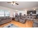 Bright living room with hardwood floors, offering views into the kitchen and dining areas, ideal for entertaining at 1014 Coastal Hammock Ave, Ruskin, FL 33570