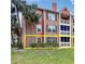 Charming brick condo with a private patio surrounded by lush greenery and palm trees in a vibrant community at 10200 Gandy N Blvd # 412, St Petersburg, FL 33702