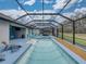 Enclosed pool area with a large swimming pool, relaxing lounge chairs, and a spacious deck at 12811 Wheatgrass Ct, Parrish, FL 34219
