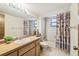 Bathroom with a single sink vanity, bright lighting, and a shower with a curtain at 1286 Barranca Ave, Spring Hill, FL 34609