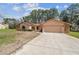 Attractive single-story home featuring stone accents, an attached two-car garage, and a well-maintained front yard at 1286 Barranca Ave, Spring Hill, FL 34609