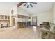Bright living space with hardwood floors, bar seating, and a ceiling fan, creating a cozy atmosphere at 1286 Barranca Ave, Spring Hill, FL 34609