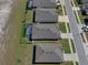 Aerial view of neighborhood homes showcasing backyard pools, well-kept lawns, and residential street at 13359 Golden Lime Ave, Spring Hill, FL 34609