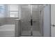 Bathroom with glass enclosed shower and soaking tub at 13359 Golden Lime Ave, Spring Hill, FL 34609