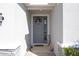 Inviting front entrance with decorative wreath, accent decor, and stone pillar accents at 13359 Golden Lime Ave, Spring Hill, FL 34609