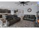 Open-concept living space with modern tile, neutral paint, fireplace, and dark cabinetry in kitchen at 13359 Golden Lime Ave, Spring Hill, FL 34609