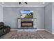 Comfortable living room features a decorative fireplace and entertainment center at 13359 Golden Lime Ave, Spring Hill, FL 34609