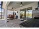 Covered patio with ceiling fans and space for outdoor seating and dining near the pool at 13359 Golden Lime Ave, Spring Hill, FL 34609