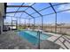 Inviting in-ground pool with a screened enclosure, providing a perfect outdoor retreat at 13359 Golden Lime Ave, Spring Hill, FL 34609