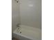 The bathroom features white tiled shower and tub at 13728 1St St, Dade City, FL 33525
