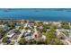 Aerial view of the property with water views and lush landscape at 138 Edgewater Ter, Dunedin, FL 34698