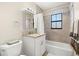 Well-lit bathroom with a granite vanity top, and a shower-tub combination at 138 Edgewater Ter, Dunedin, FL 34698