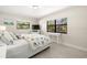Sunlit bedroom with hardwood floors, a large window, and tasteful beach-themed accents at 138 Edgewater Ter, Dunedin, FL 34698
