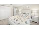 Comfortable bedroom with coastal-themed bedding, complemented by crisp white walls and trim at 138 Edgewater Ter, Dunedin, FL 34698