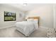Inviting bedroom features wood-look floors, a window, and an inviting bed at 138 Edgewater Ter, Dunedin, FL 34698