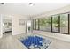 Bedroom with large windows, wood-look flooring, and serene natural light at 138 Edgewater Ter, Dunedin, FL 34698