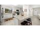 Well-lit kitchen with white cabinetry, granite counters, and stainless steel appliances at 138 Edgewater Ter, Dunedin, FL 34698