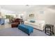 Comfortable living room featuring a plush sofa, leather armchair and ottoman, with a glimpse of the dining area at 138 Edgewater Ter, Dunedin, FL 34698